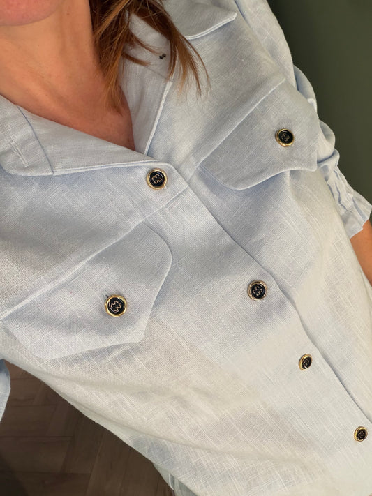 Camisa de lino azul claro con botones dorados – Pietra Madrid · PORTICO Concept, Turó Park Barcelona